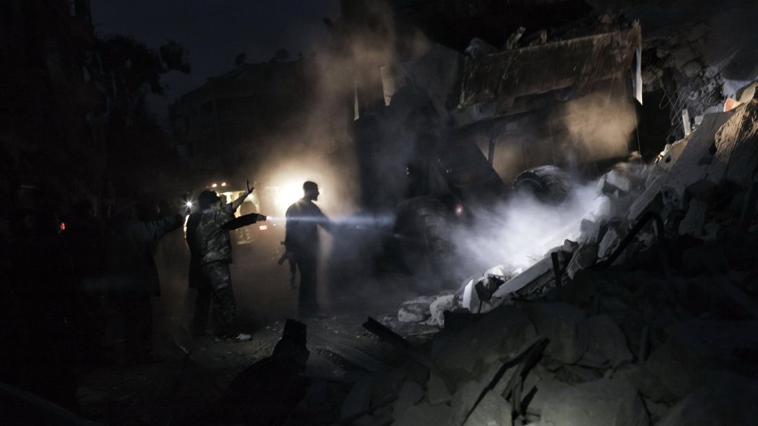 Syrians look for survivors amid the rubble of a building targeted by a missile in the al-Mashhad neighborhood of Aleppo on January 7, 2013.