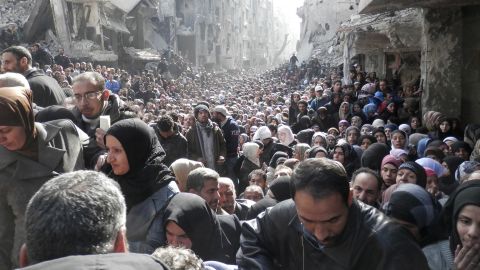 Displaced Syrian residents wait to receive food aid distributed by the UN Relief and Works Agency at the besieged al-Yarmouk camp, south of Damascus, Syria, on January 31, 2014. According to the UN Envoy for Syria, an estimated 400,000 Syrians have been killed since an uprising in March 2011 spiraled into civil war. See how the conflict has unfolded.