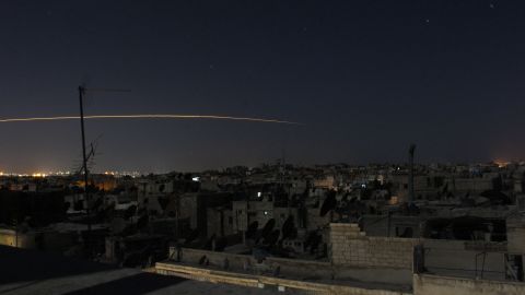 A long-exposure photograph shows a rocket being launched in Aleppo on October 5, 2014.
