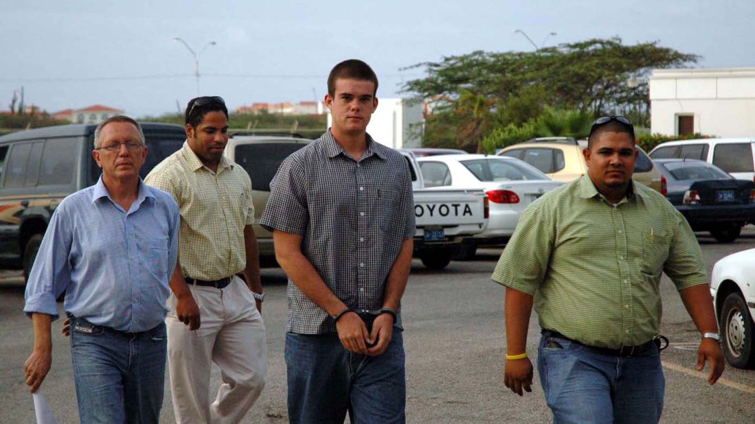 Joran van der Sloot, center, arrives at the hospital for DNA tests in July 2005, Today, van der Sloot is in prison in Peru after being convicted of murdering Stephany Flores in 2010.