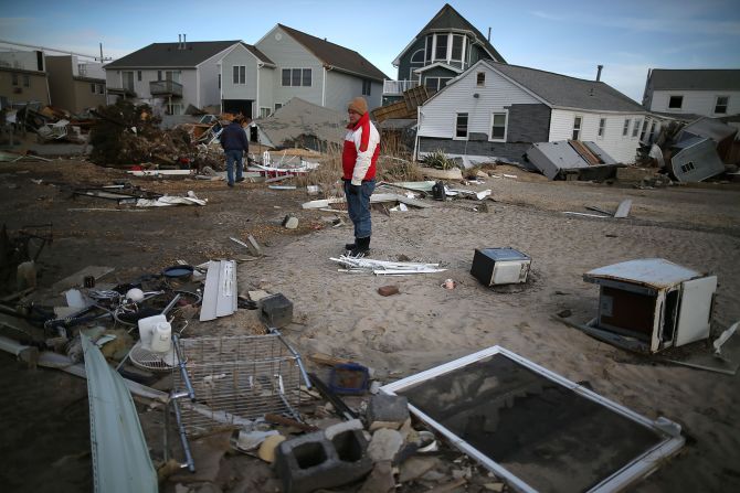 <strong>Sandy, 2012:</strong> It technically lost its hurricane status shortly before striking New Jersey, but its gigantic size -- it covered 1.8 million square miles at landfall -- sent devastating storm surges to the coast. Here, a man looks for pieces of his beach house after <a href="index.php?page=&url=http%3A%2F%2Fwww.cnn.com%2F2013%2F07%2F13%2Fworld%2Famericas%2Fhurricane-sandy-fast-facts%2F">Sandy </a>demolished it in Seaside Heights, New Jersey. With 72 directly killed in eight states, this was the most deadly tropical cyclone outside the South since 1972's Hurricane Agnes. At least 650,000 U.S. homes were damaged or destroyed in the U.S.