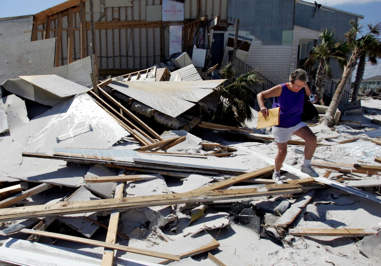 <strong>Ivan, 2004</strong>: This year also was hurricane-heavy, punctuated by <a href="http://www.nhc.noaa.gov/data/tcr/AL092004_Ivan.pdf" target="_blank" target="_blank">Ivan</a>, a storm with two lives. First, it killed dozens in the Caribbean and  slammed into Alabama. Later, its remnants went back over Florida from the Atlantic and re-formed in the Gulf as a tropical storm, making another landfall in southwestern Louisiana. It spawned more than 100 tornadoes, one of the factors that left considerable damage across the Southeast and some mid-Atlantic states. Here, a woman walks over debris as she visits her home, destroyed by Ivan, in Perdido Key, Florida, on September 20.