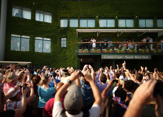 When his moment of glory arrived, Andy Murray took to the Centre Court balcony to display the trophy to throngs of fans gathered outside.