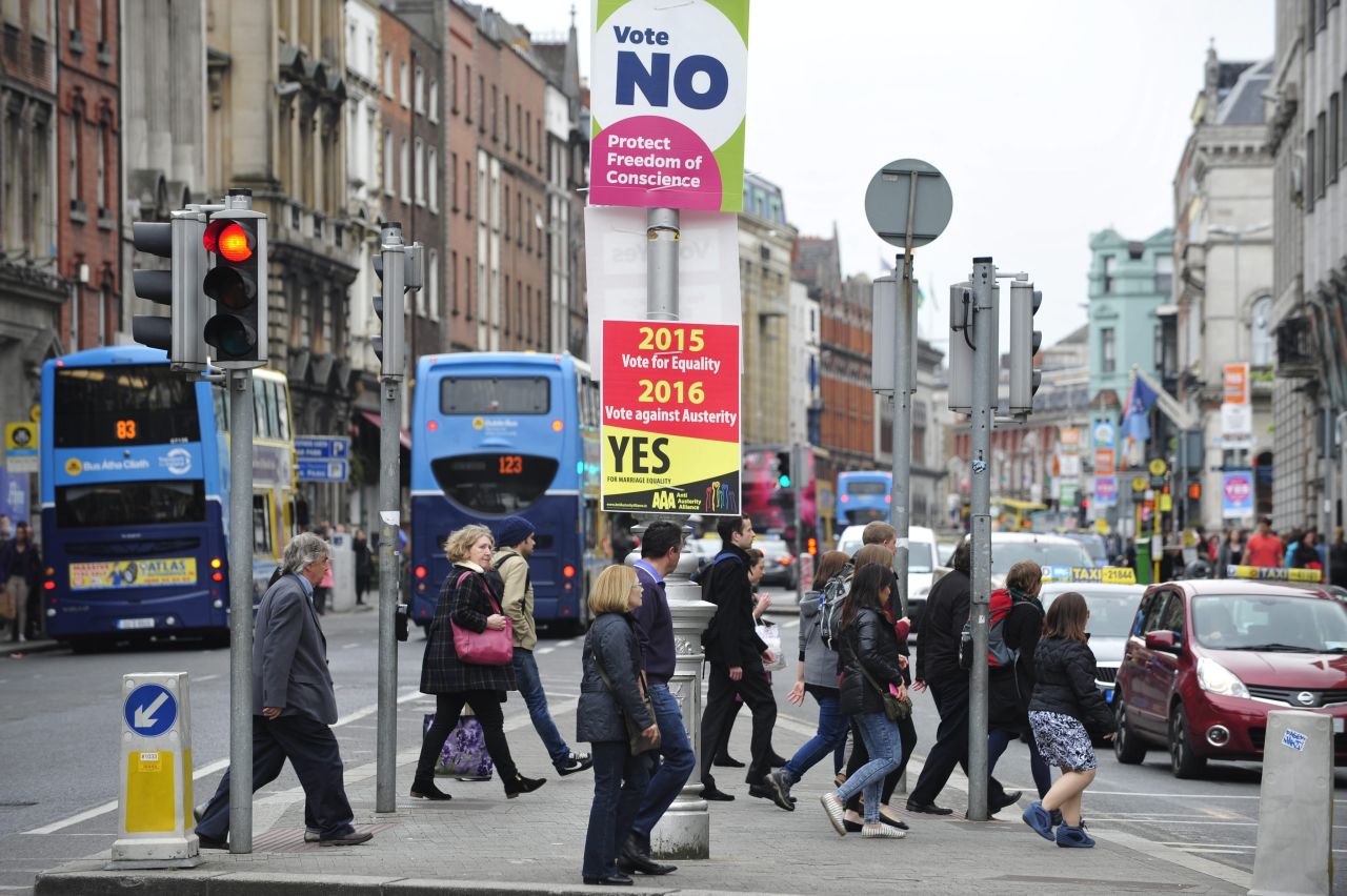 Pesdestrians cross a street next to placards on the same-sex marriage referendum in Dublin, Ireland, on May 22. 