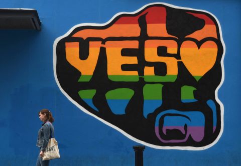 A woman walks past a mural promoting the "Yes" campaign in favor of same-sex marriage on May 22 in Dublin, Ireland. 