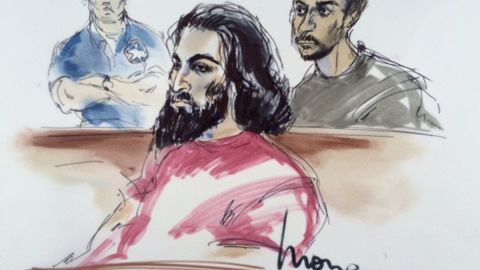 In the courtroom on Friday are defendants Nader Elhuzayel (in red, in foreground) and Muhanad Badawi (in upper right). Behind them, to left, is a U.S. marshal. 