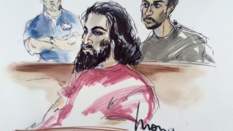 In the courtroom on Friday are defendants Nader Elhuzayel (in red, in foreground) and Muhanad Badawi (in upper right). Behind them, to left, is a U.S. marshal.
