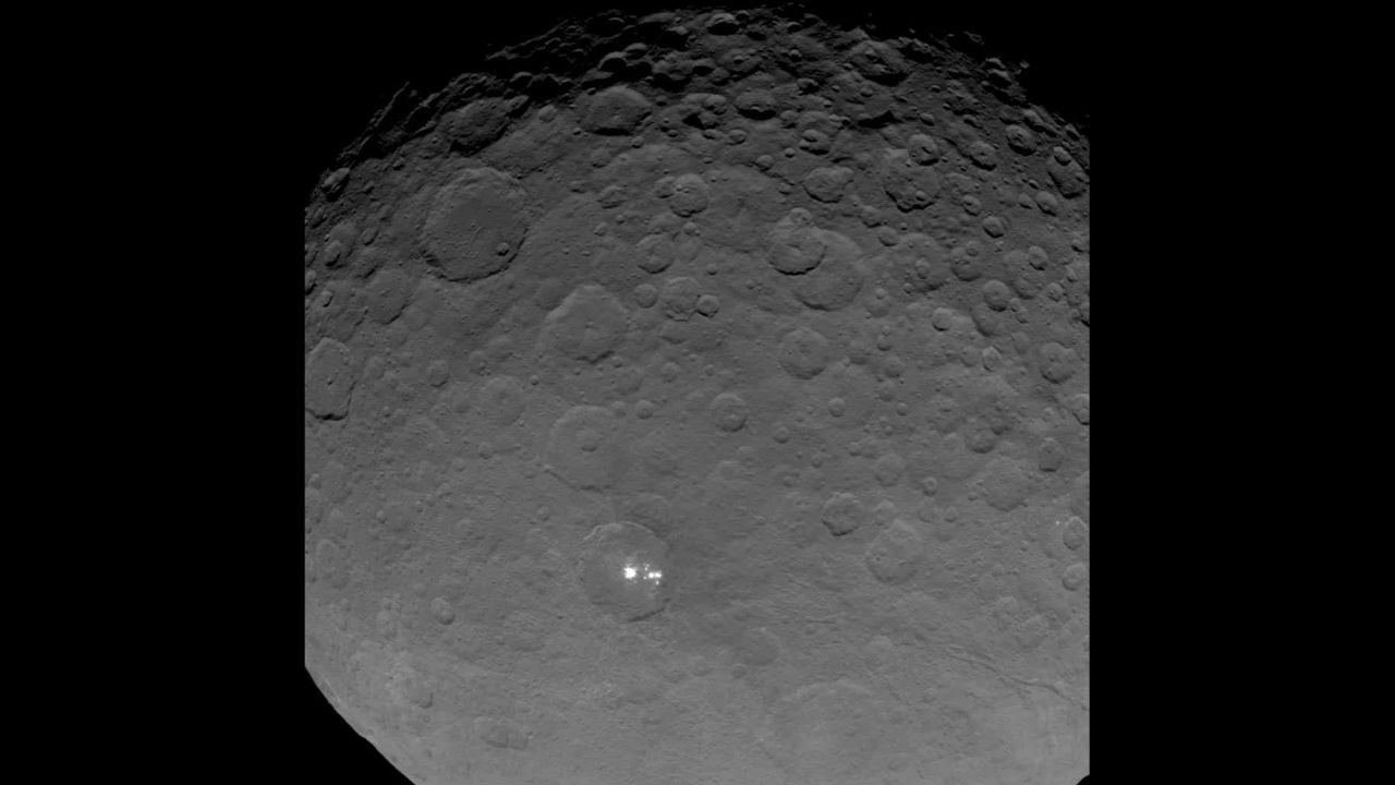 Dawn gave scientists a big surprise: Ceres has a group of bright spots glowing inside a large crater. The above image is part of a sequence taken by Dawn on May 16, 2015 when the spacecraft was 4,500 miles (7,200 kilometers) away from Ceres. It's the closest view yet of the spots. But what are they? According to the mission's principal investigator, Christopher Russell, scientists have concluded the spots are "due to the reflection of sunlight by highly reflective material on the surface, possibly ice."