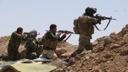 Iraqi soldiers and Shiite fighters from the popular committees hold a post as they fire towards Islamic State (IS) group positions in the Garma district of Anbar province west of the Iraqi capital Baghdad, on May 19, 2015. Iraq's army and allied paramilitary forces massed around Anbar's provincial capital Ramadi, looking for swift action to recapture the city from the Islamic State group before it builds up defences.