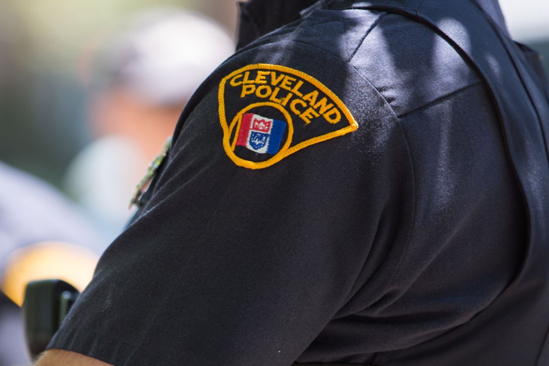 A Cleveland police officer looks on as people take to the streets and protest in May 2015.