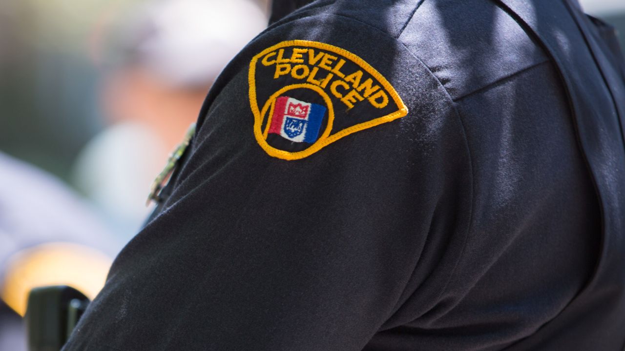 A Cleveland police officer looks on as people take to the streets and protest in May 2015.