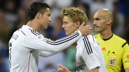 Real Madrid's Portuguese forward Cristiano Ronaldo (L) is substituted by Real Madrid's Norwegian midfielder Martin Oedegaard during the Spanish league football match Real Madrid CF vs Getafe CF at the Santiago Bernabeu stadium in Madrid on May 23, 2015. AFP PHOTO / PIERRE-PHILIPPE MARCOU (Photo credit should read PIERRE-PHILIPPE MARCOU/AFP/Getty Images)