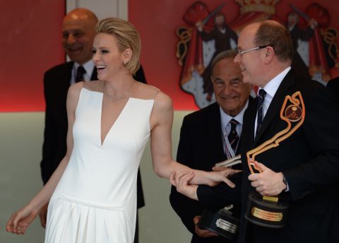 Prince Albert II of Monaco (right) and his wife Princess Charlene share a laugh on the podium  after Rosberg's victory.