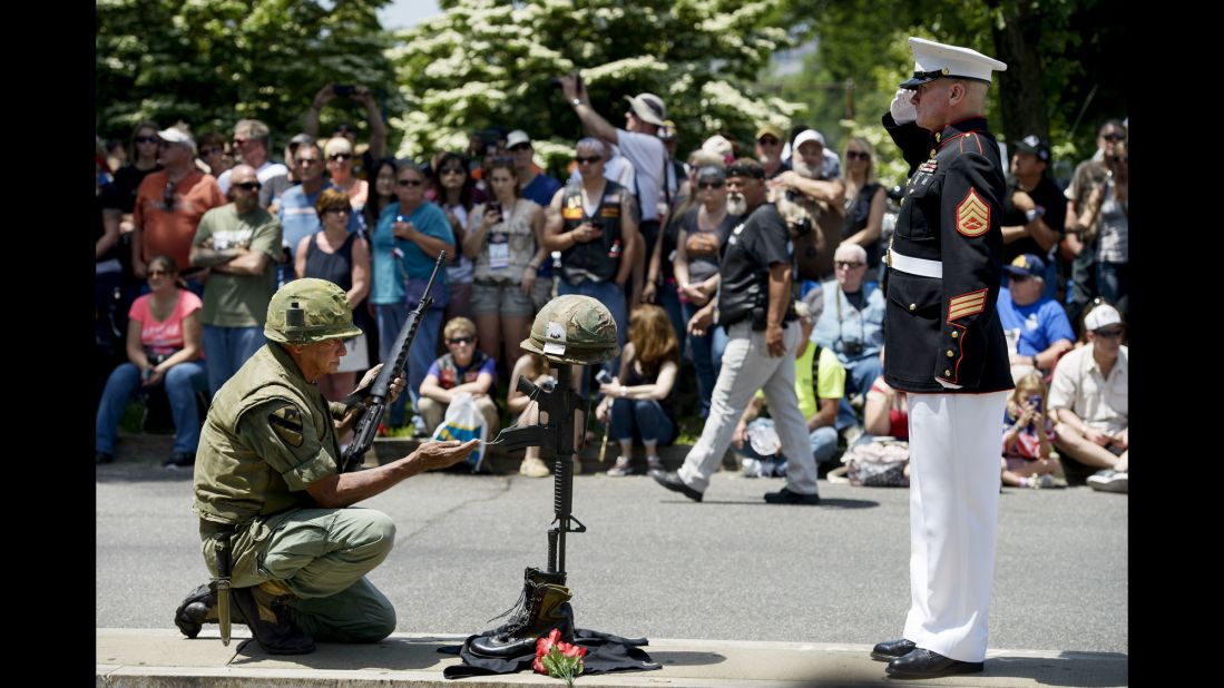 A Marine salutes a makeshift memorial during Rolling Thunder in Washington.