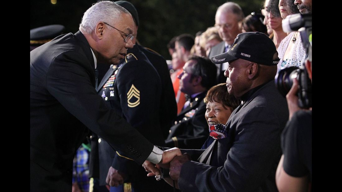 Former Secretary of State Colin Powell greets disabled veteran Ted Strong at the National Memorial Day Concert in Washington on May 24.