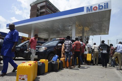 People lining up to buy fuel earlier this year at a Mobil gas station in Lagos, Nigeria. A fuel shortage has caused massive disruption for a country which relies on fuel for its cars but also for powering its generators. 