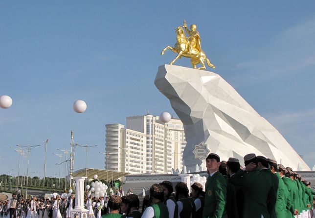 Young Turkmen men and women take part in an opening ceremony of the first monument to Turkmenistan's current president Gurbanguly Berdymukhamedov in Ashgabat