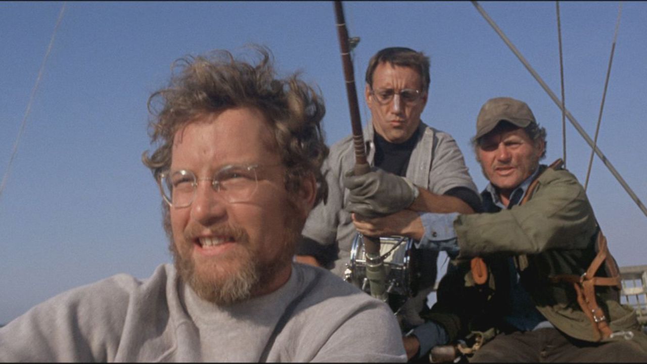 In this scene the trio use a fishing rod in a futile attempt to land the shark. Shaw's salty Quint character was partly inspired by Captain Ahab, the obsessed whale hunter in <em>Moby Dick.</em>