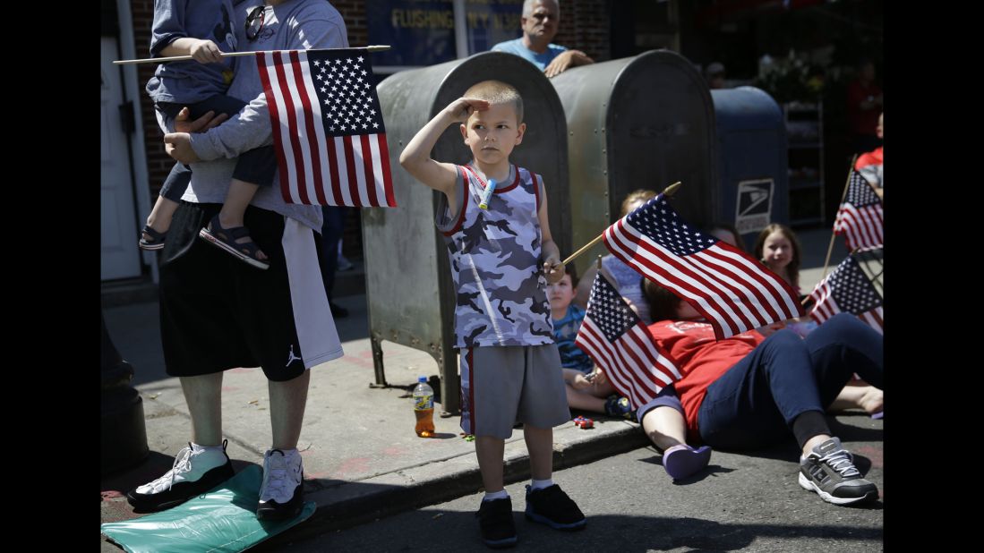 Rocco Struncius salutes as soldiers walk by during a Memorial Day parade in New York on May 25.