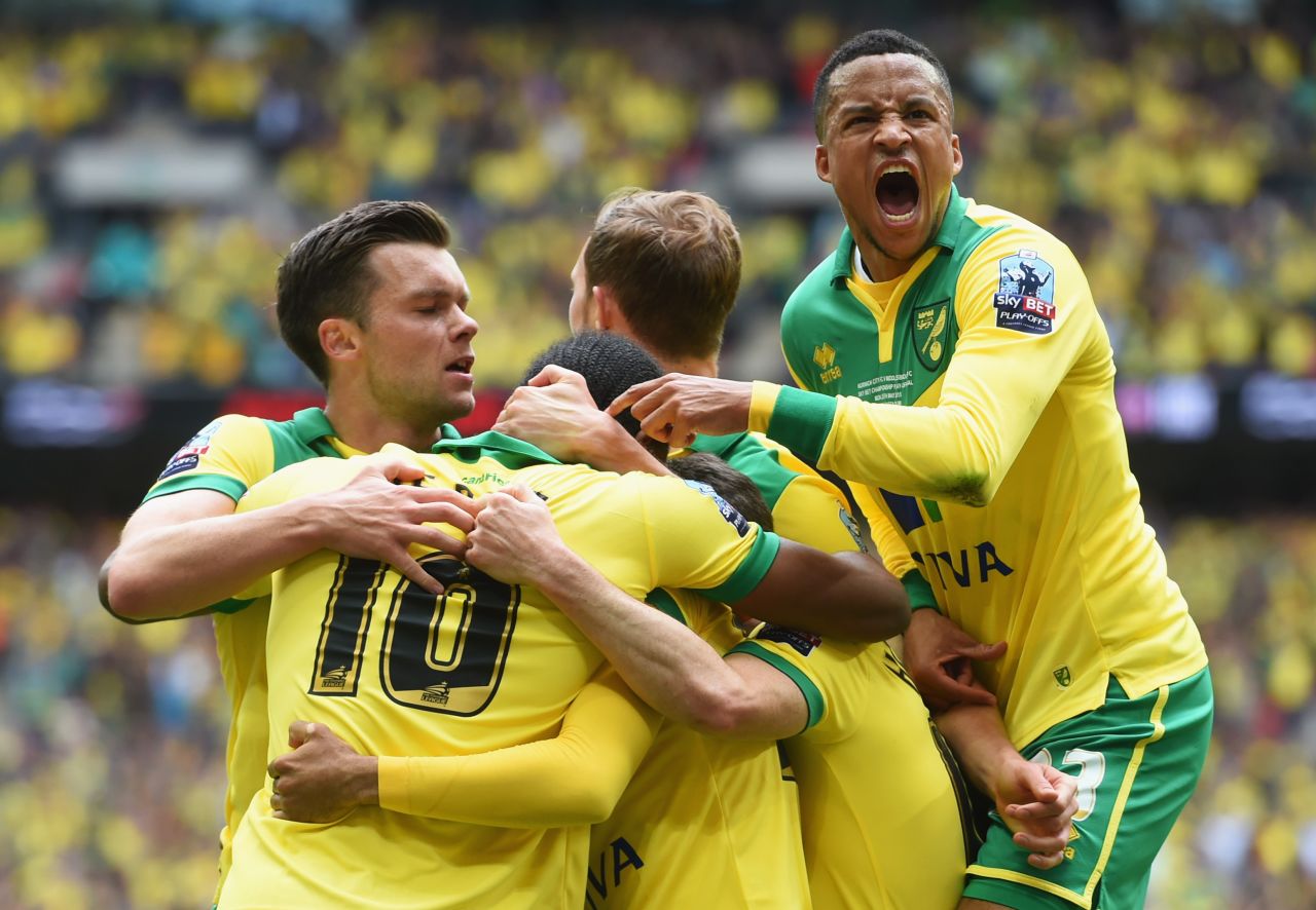 Norwich City players celebrate after taking an early lead.