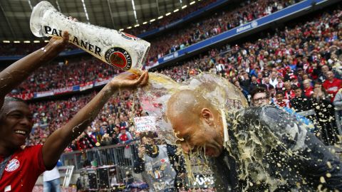 Bayern Munich's David Alaba pours beer over manager Pep Guardiola after their final Bundesliga match Saturday, May 23, in Munich, Germany. Bayern clinched the league title in late April -- its third in a row.