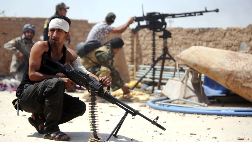 Iraqi fighters from the Shiite popular mobilisation unit hold position in the outskirts of Baiji refinery north of Tikrit, in the Salahaddin province, during a joint operation with the Iraqi army to retake the remaining area of the oil refinery from Islamic State (IS) group jihadists, on May 25, 2015.