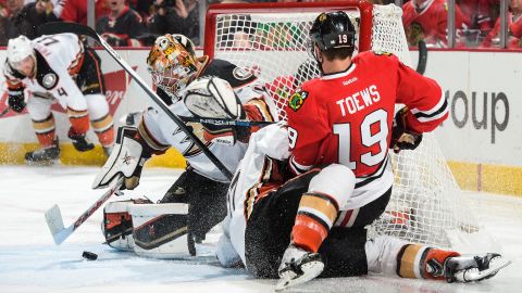 Chicago captain Jonathan Toews falls on top of Anaheim's Ryan Kesler, next to Anaheim goalie Frederik Andersen, during Game 4 of the NHL's Western Conference Finals on Saturday, May 23. Chicago won in double overtime to even the series at 2-2.