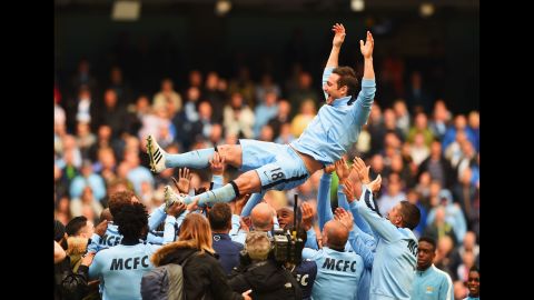 Frank Lampard is thrown into the air by his Manchester City teammates after their final match of the season Sunday, May 24, in Manchester, England. Lampard is leaving the club to play in the United States.