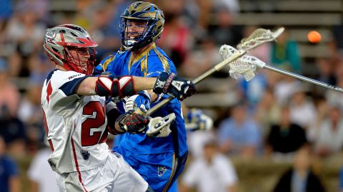 Sean Meagher of the Charlotte Hounds defends a shot by Craig Bunker of the Boston Cannons during their Major League Lacrosse game in Charlotte, North Carolina, on Saturday, May 23.