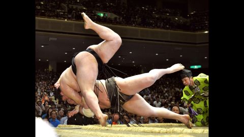 Grand champion Hakuho, bottom, is thrown down by Goeido on Thursday, May 21, during the Summer Grand Sumo Tournament in Tokyo.