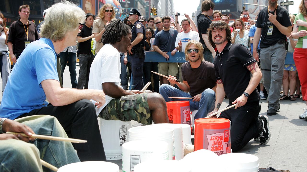 Stewart Copeland of The Police, Taylor Hawkins of the Foo Fighters and Grohl perform in a drum circle during MTV2's "24 Hours Of Foo" at New York's Times Square in 2005.