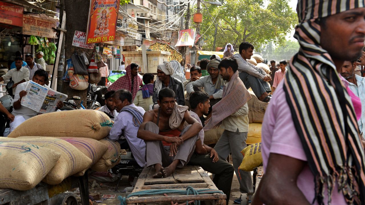 People sit in the shade of a market in New Delhi on May 26. 