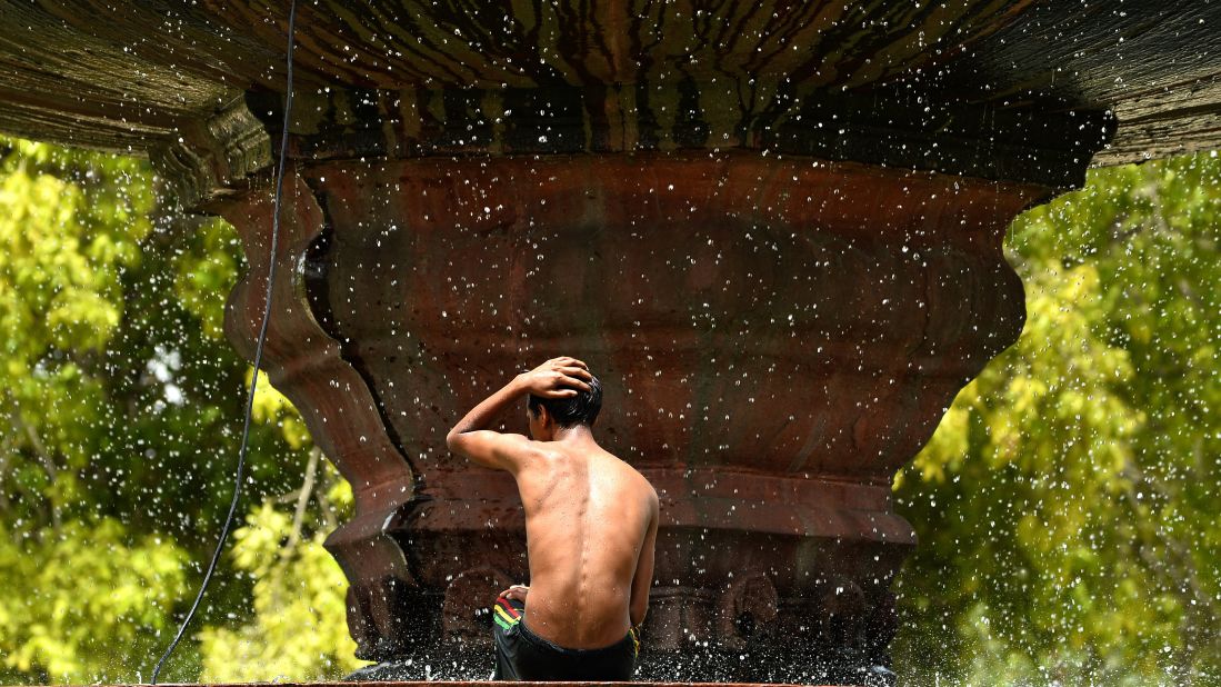 A fountain in New Delhi spells relief from the heat on May 26. Two-thirds of India's 1.2 billion people don't have access to electricity, meaning no fans or air conditioning. 