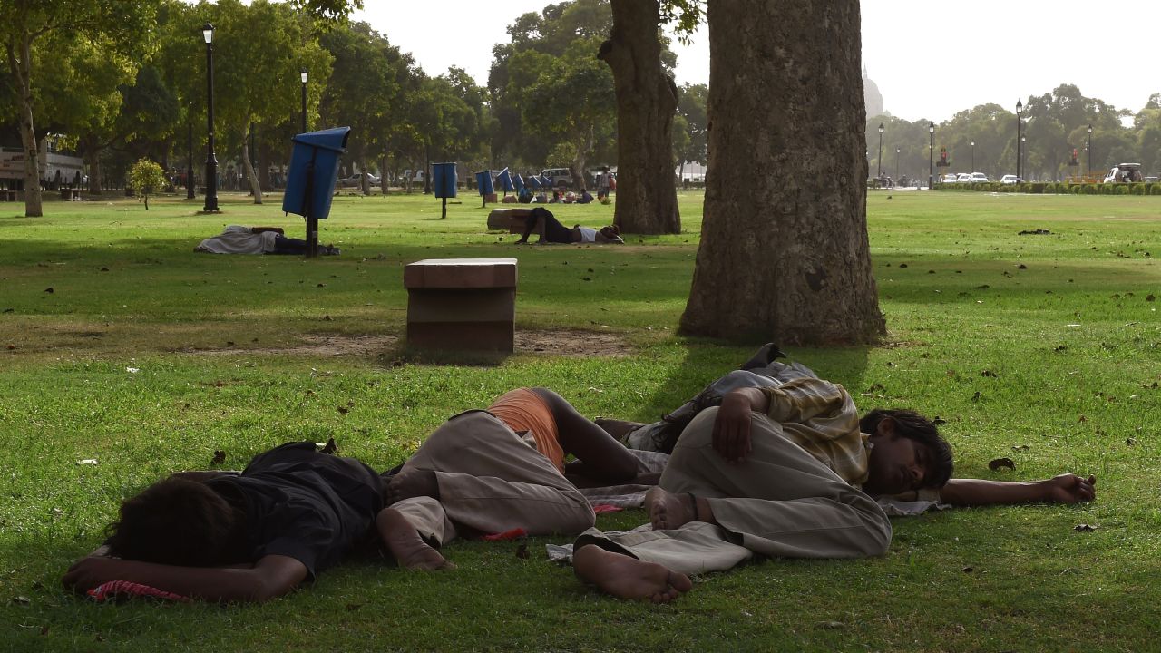 People in New Delhi rest in the shade on May 26.