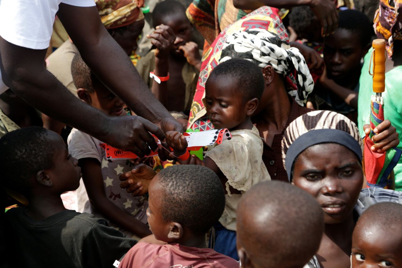 A child gets a red wristband to board the boat first. The most vulnerable refugees are allowed onto the boat first each day.