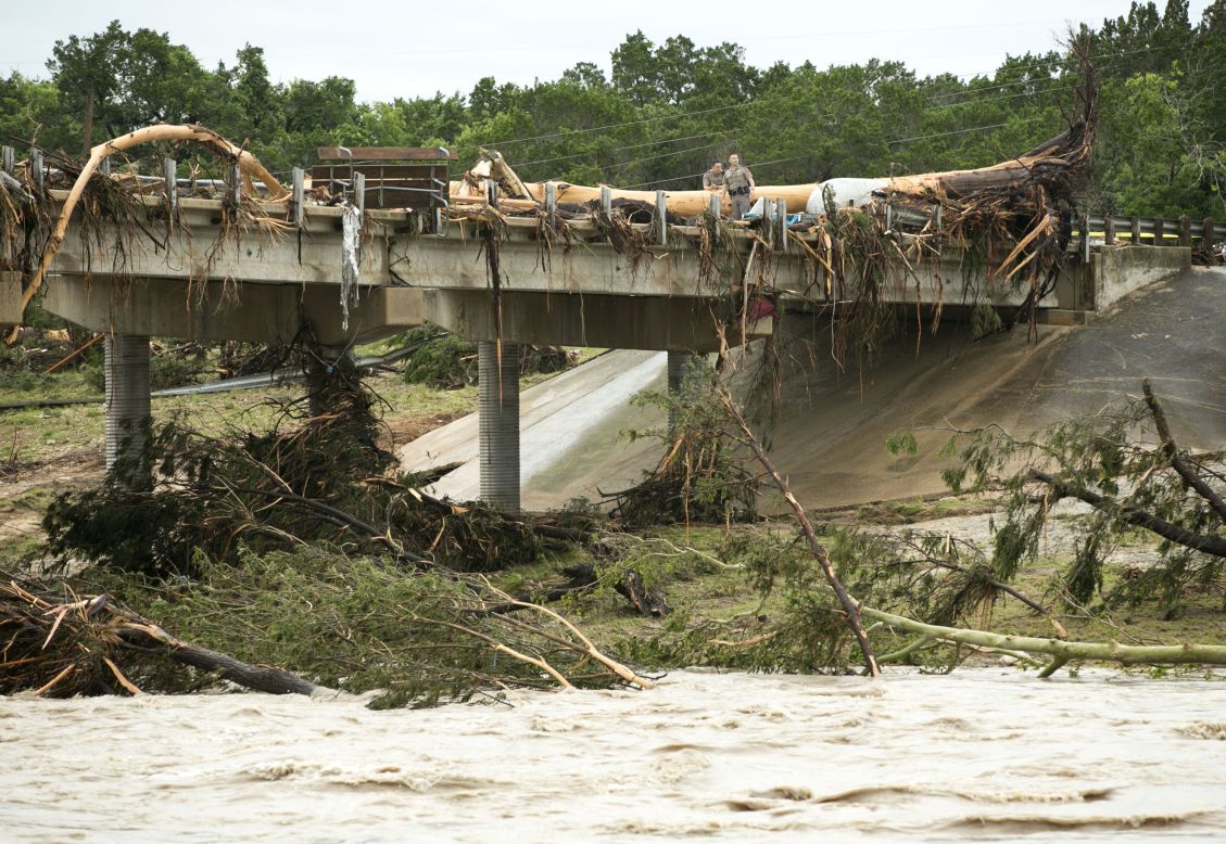 A large tree rests on the Highway 12 bridge over the Blanco River in Wimberley on May 24. 
