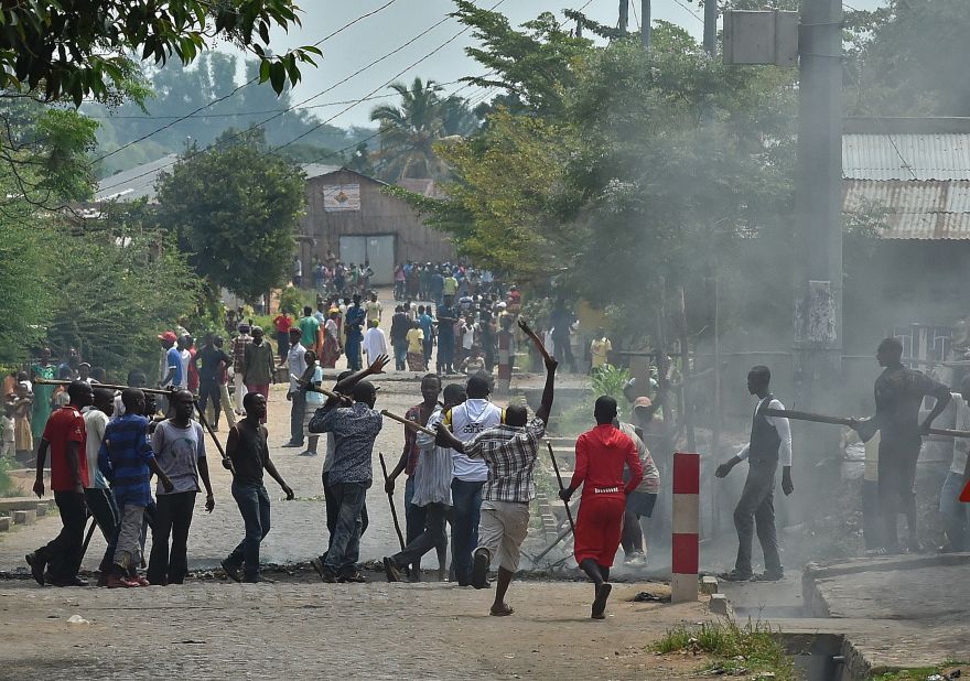 Armed with sticks, members of the Imbonerakure, the youth wing of the ruling party, grab a protester Monday, May 25, in Bujumbura.