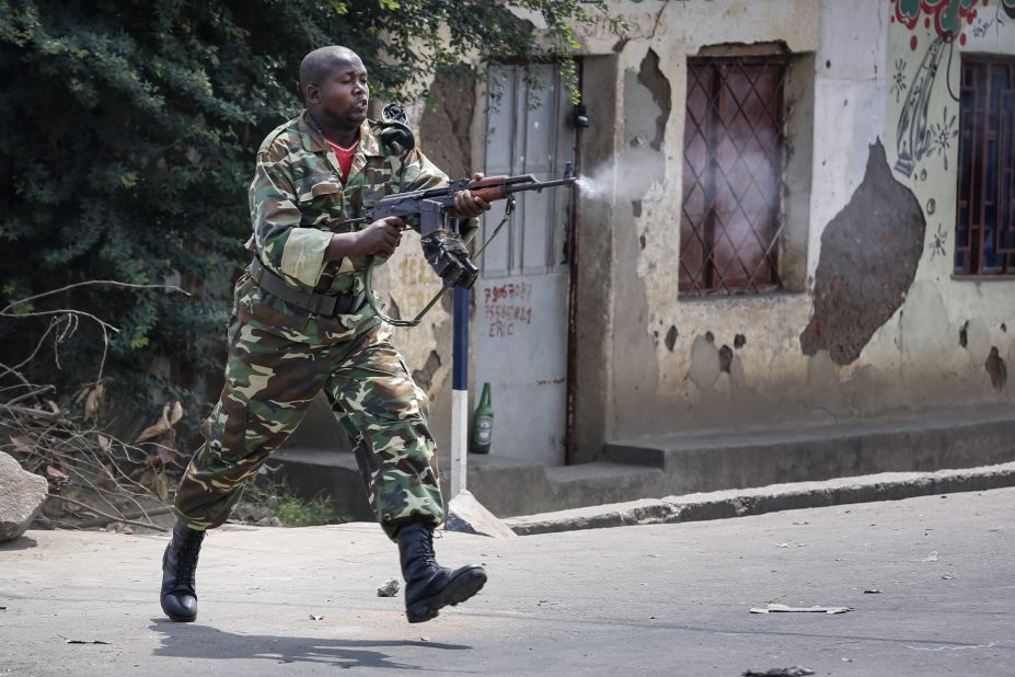 A Burundian soldier fires a shot toward protesters at an anti-government demonstration in Bujumbura on May 25.