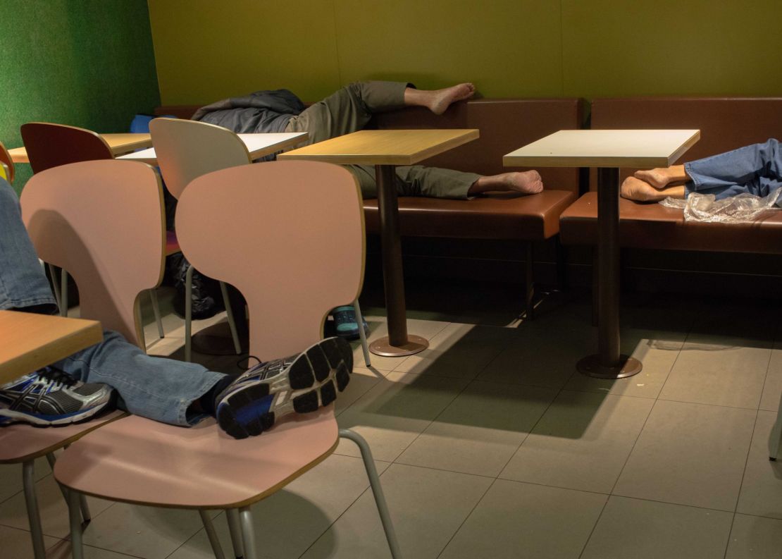 People sleep at a McDonald's in 2015.