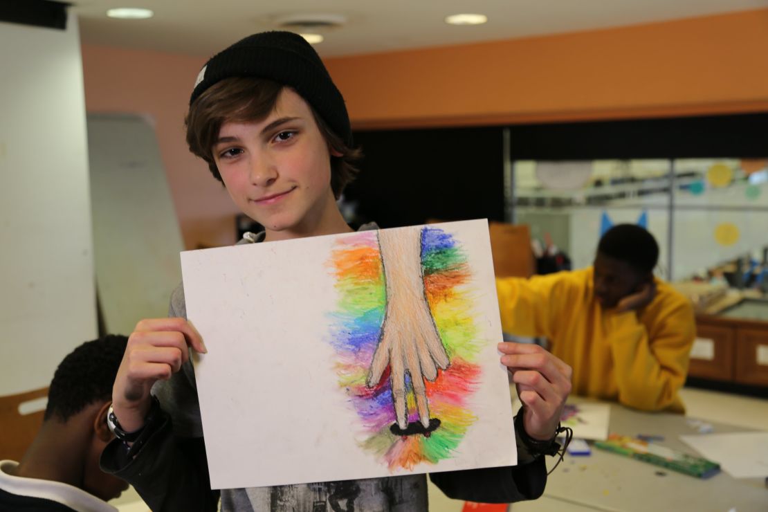 A student shows off his artwork created at one of the free ProjectArt classes in New York City.   