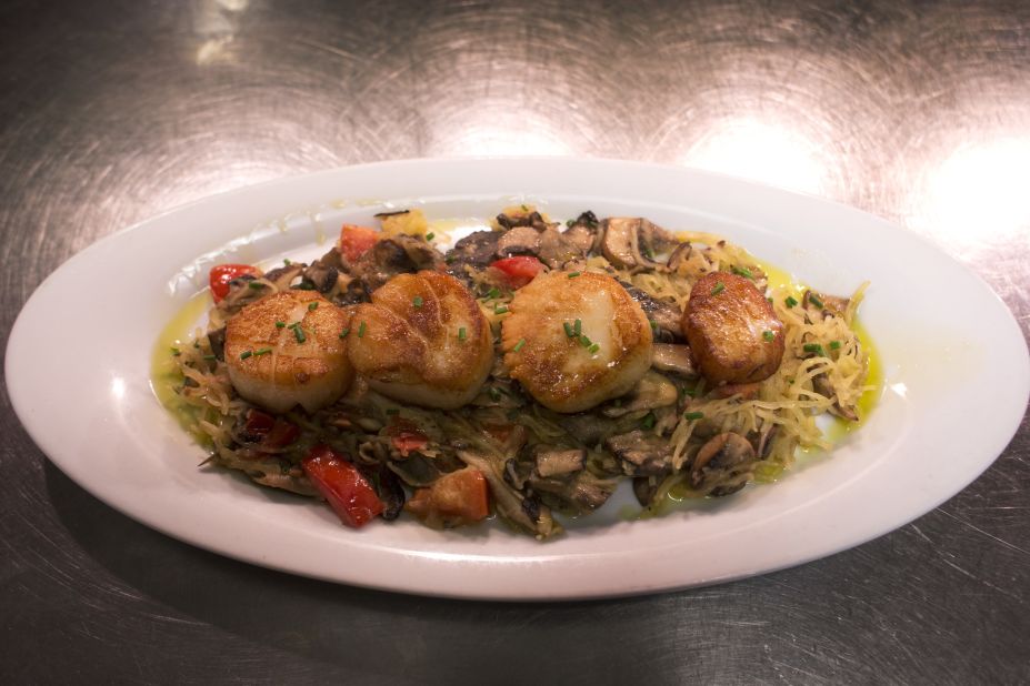 Vicki Gold Levi is one of those residents: Her dad was the chief photographer for the city from the 1930s to the 1960s, and she grew up walking down the then-bustling boardwalk. Tony shares pan-seared scallops with her at the The Knife & Fork Inn in Atlantic City. 
