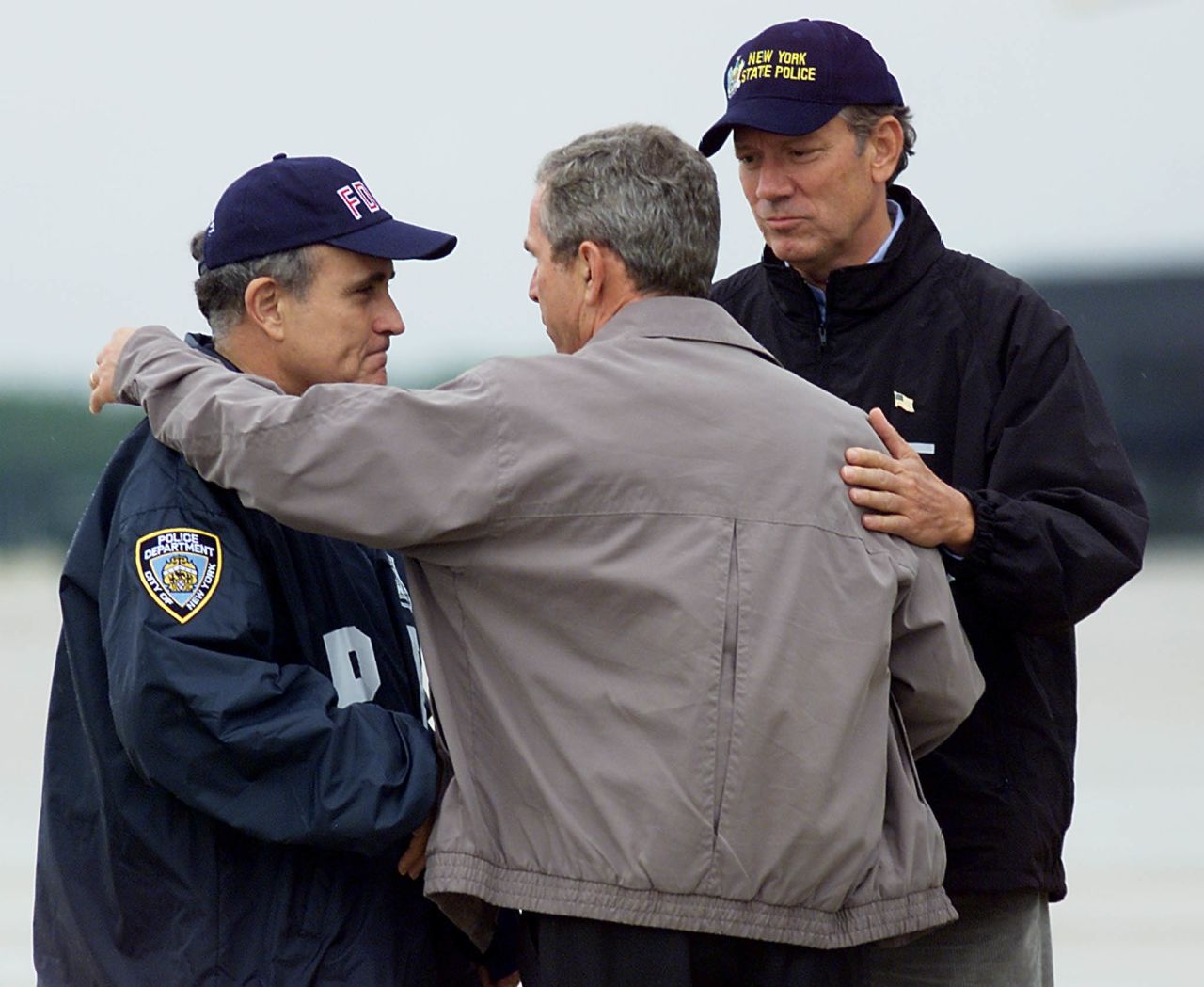 Then-U.S. President George W. Bush, center, greets then-New York City Mayor Rudy Giuliani, left, and then-New York Governor George Pataki September 14, 2001 in New York. 
