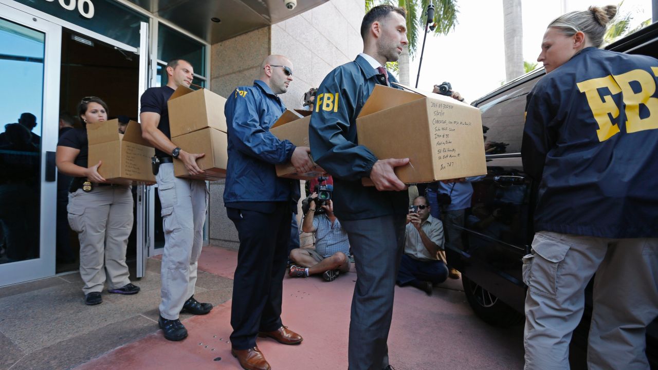 FBI agents carry boxes from the headquarters of CONCACAF in Miami Beach, Florida, after it was raided as part of an international investigation of FIFA. 