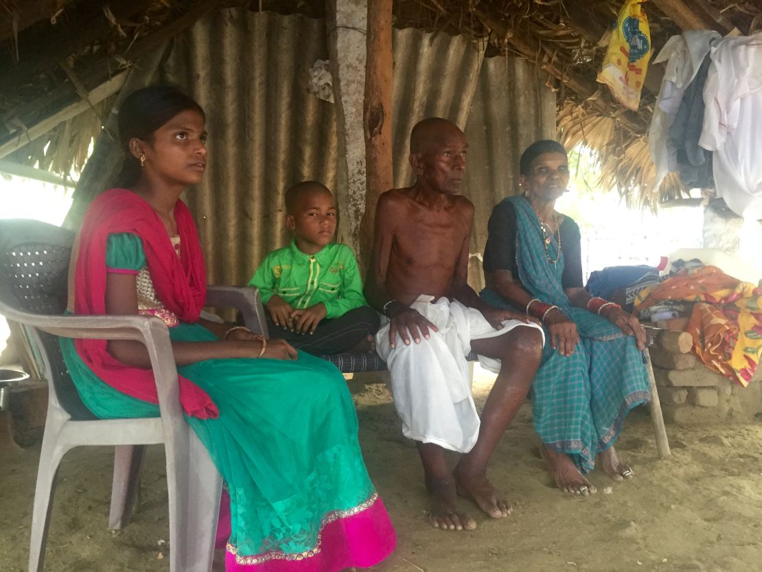Mallayia Baddula sits with his family in the stiflying heat of their hut in Perepally, outside Hyderabad.