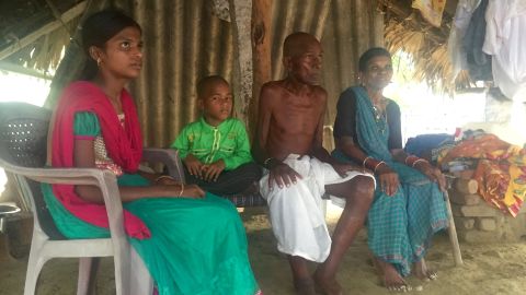 Mallayia Baddula sits with his family in the stiflying heat of their hut in Perepally, outside Hyderabad.