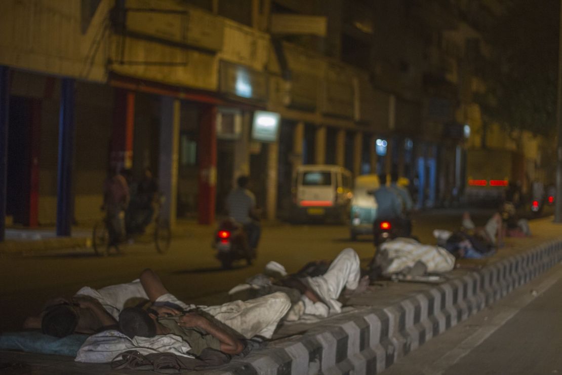 Men sleep on concrete road dividers during a heat wave in Delhi on May 27.