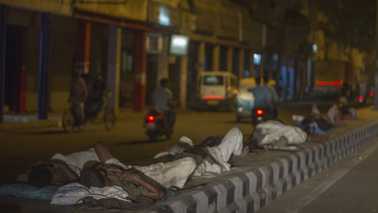 Men sleep on concrete road dividers during a heat wave in Delhi on May 27.