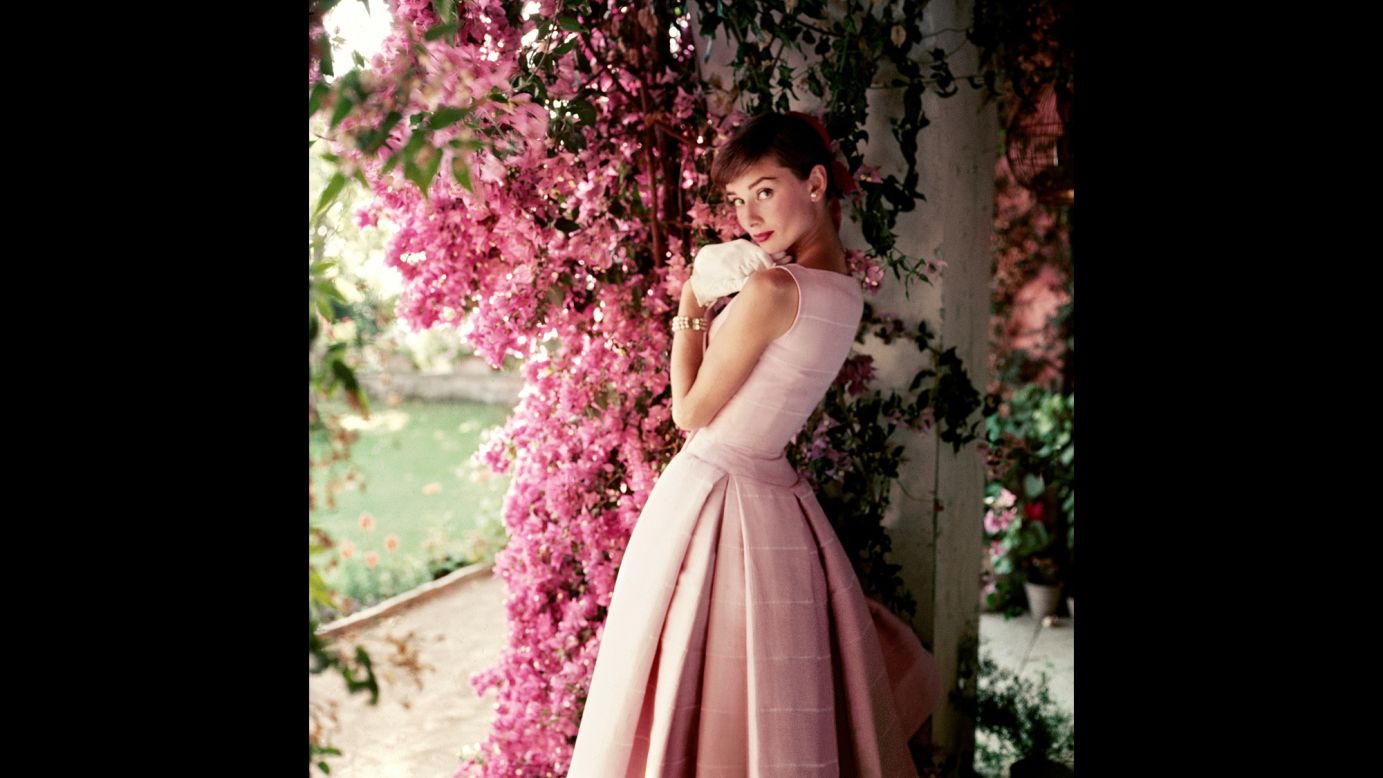 Hepburn poses at her rented farmhouse near Rome in this 1955 photo by Norman Parkinson. She is wearing a Givenchy cocktail dress from the Spring/Summer 1955 collection. "The narrow waist and full pleated skirt of the dress are typical of the 'New Look' silhouette which was so popular in the post-war period," Trompeteler wrote.