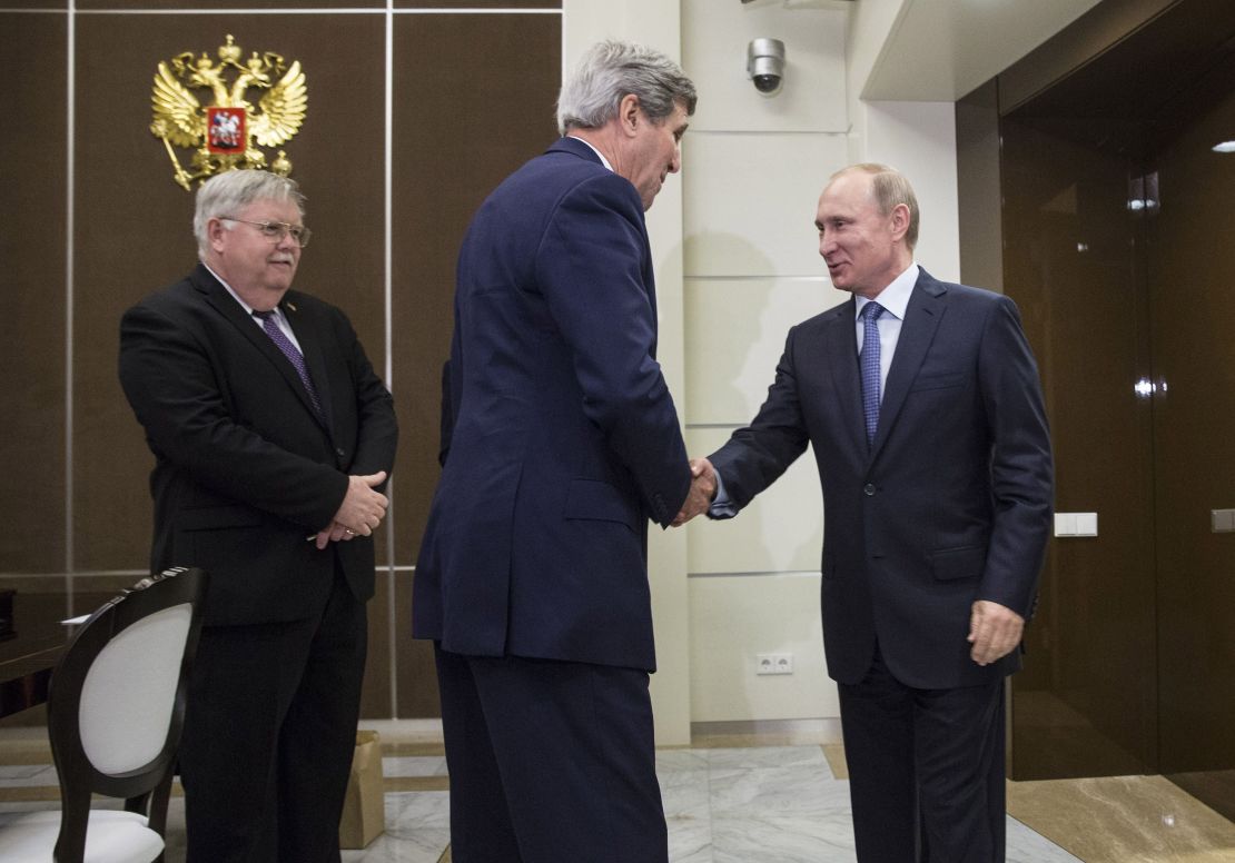U.S. Secretary of State John Kerry shakes hands with Russia's President Vladimir Putin, next to U.S. Ambassador to Russia John Tefft at the presidential residence Bocharov Ruchey in Sochi.