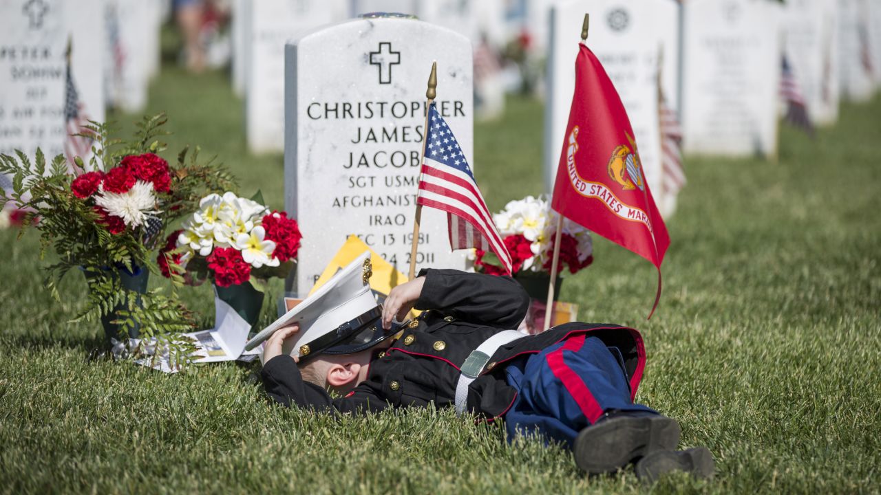Christian Jacobs, 4, lies on the grave of his father, Christopher James Jacobs, during a <a href="http://www.cnn.com/2015/05/23/us/gallery/memorial-day-2015/index.html" target="_blank">Memorial Day</a> event Monday, May 25, at Arlington National Cemetery in Virginia. 